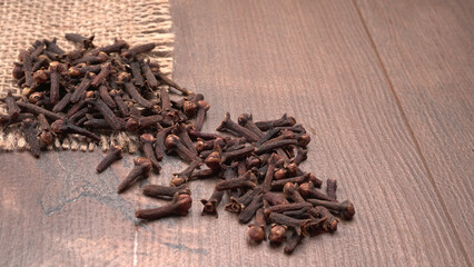 Cloves on vintage wooden background.
