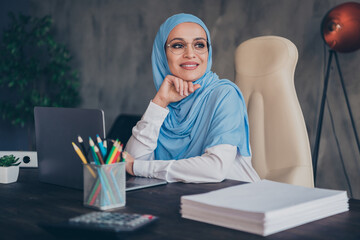 Photo of optimistic millennial arabic lady with laptop wear glasses headscarf shirt indoors at home workstation