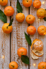Tangerines with leaves on a rustic wooden background