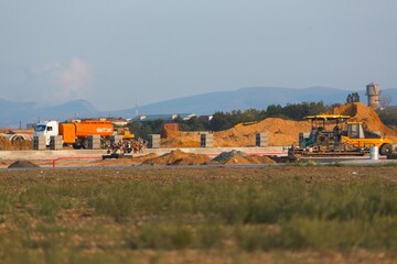 Big construction site on the outskirts near the road