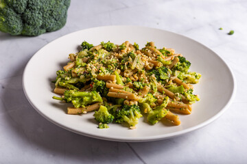Vegan wholemeal pasta with broccoli and chopped hazelnuts.CR2Vegan wholemeal pasta with broccoli and chopped hazelnuts
