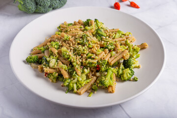 Vegan wholemeal pasta with broccoli and chopped hazelnuts
