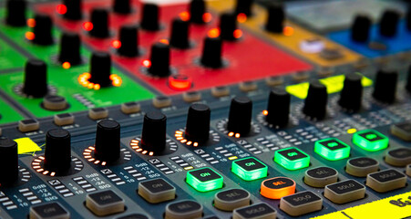 Sliders and buttons on Audio Mixing Desk at live event.