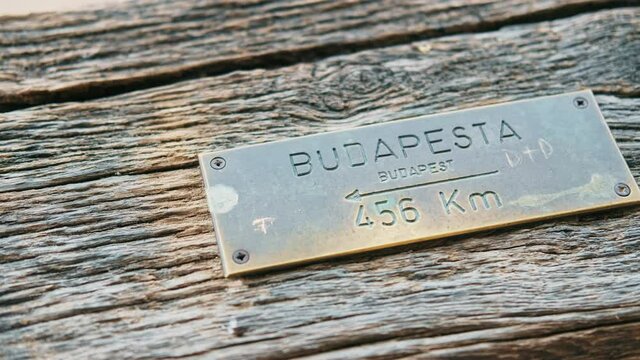 Direction and distance to Budapest city metal sign on a wooden wall