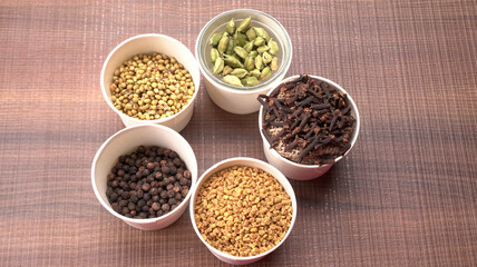 Collection of indian Spices and herbs. Food and cuisine ingredients on wooden background.