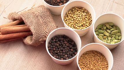 Collection of indian Spices and herbs. Food and cuisine ingredients on wooden background.
