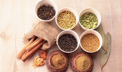 Collection of indian Spices and herbs. Food and cuisine ingredients on wooden background.