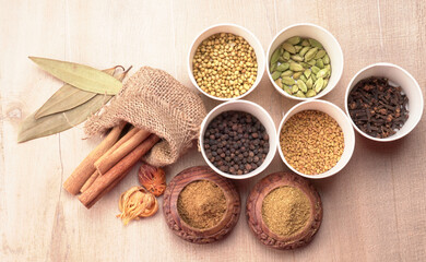 Collection of indian Spices and herbs. Food and cuisine ingredients on wooden background.