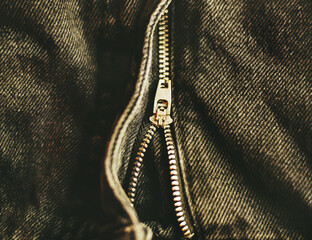 The zipper is unbuttoned on the gray fashionable comfortable jeans.  Trendy casual clothes. Zipper...