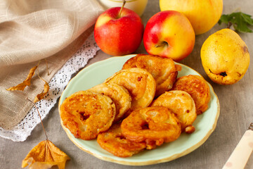 Apples in the dough on a table with caramel sauce
