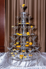 Tower of empty champagne glasses. Photo of champagne glasses pyramid on a table. Glasses of bubbling champagne