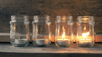 Candle burning on a rustic wooden table
