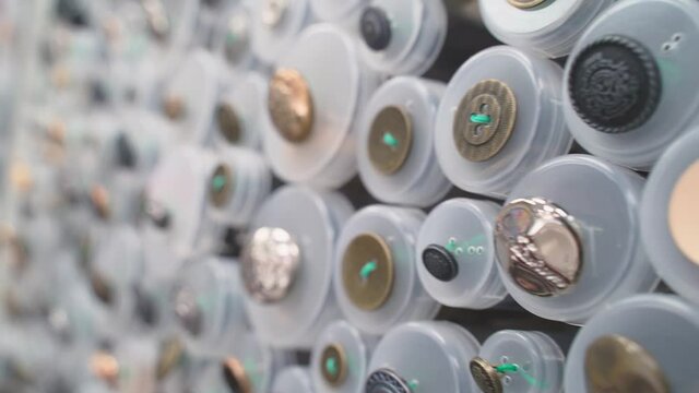 set of multi-colored buttons for sewing clothes, creativity, needlework, fabric. Hobby and tailor shop window with fabrics and button