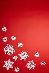 Christmas decoration with white paper snowflakes on red