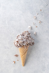 A waffle cone for ice cream lies in the background. On top of the horn, hydrangea flowers are like a cap on top.