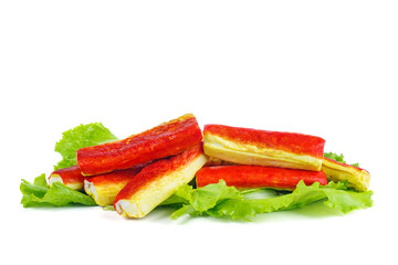 Pile of fried crab sticks on green lettuce isolated on a white background