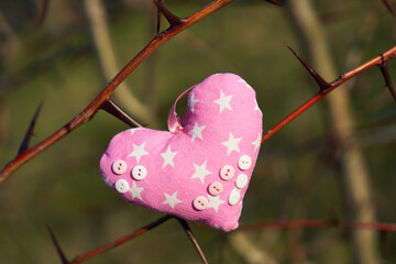 An image of a soft toy in the shape of a heart. Handicraft work.