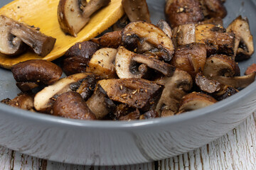 Sauteed mushrooms close up, white bowl