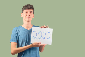 Guy showing 2022 sign for new year, isolated on plain background.