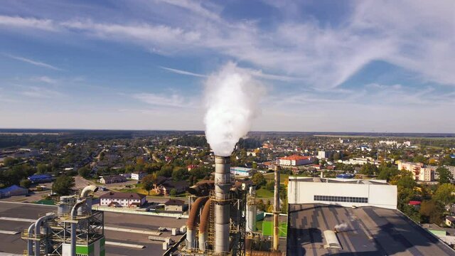 Smoke tower of industrial factory. Chimney smokestack emission.Refinery plant with pipes. Plant with smoke frow pipe and environmental pollution. Ecology concept and poor environment.