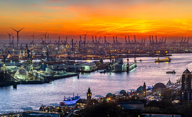 The beautiful harbour of Hamburg from above with luxury super-yacht in the dock and cranes on the...