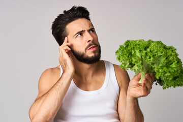 Cheerful man lettuce leaves healthy food posing