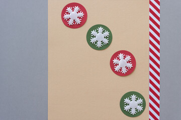 christmas themed background with fabric snowflakes on circles and ribbon