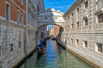 Obraz premium gondola with tourists travelling through the narrow canals of the old town of Venice