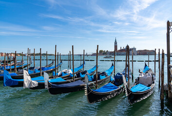 moored and tied up gondolas on the canals of Venice