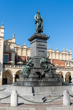view of the main square in Krakow with the statue of Adamowi Narod