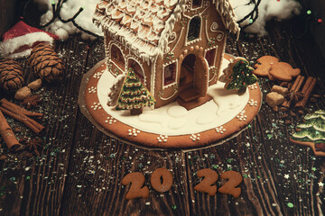 Gingerbread cookies for new 2022 year on wooden background, xmas theme