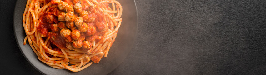 A plate of freshly cooked SPAGHETTI MEATBALLS Like an Italian banner with copy space