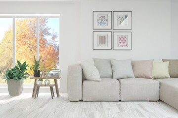 Stylish room in white color with sofa and autumn landscape in window. Scandinavian interior design. 3D illustration