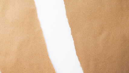 Torn craft paper edge on white background. Torn paper. Paper backgrounds. Texture of cardboard and craft paper. White background.