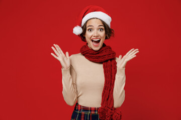 Young surprised amazed impressed shocked caucasian woman 20s wear Santa Claus Christmas red hat...