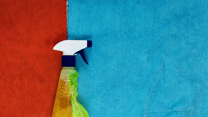 spray window cleaner lies on cleaning rags blue and red. Selective focus. Cleaning of premises....