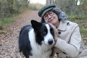 Senior woman with cute dog in the park