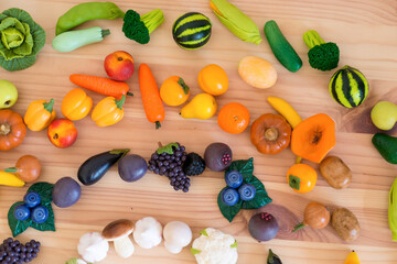Cut vegetables arranged as a rainbow on wooden surface.Also available in vertical format.