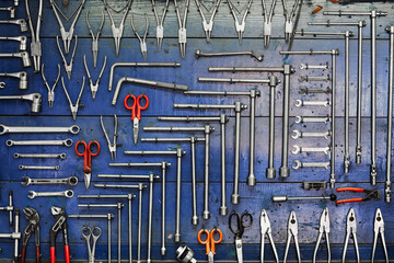 Set of work tools hanging on a wall in a workshop