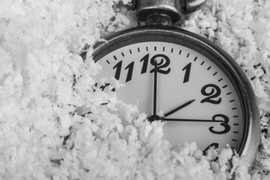 Clock in white snow. View from above.