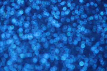 Blue sparkle blurry background with blurred dots texture