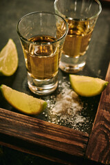 Shots of tequila with slices of lime and salt