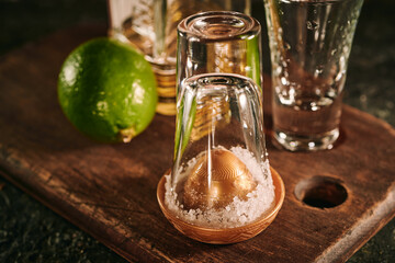 Shots of tequila with slices of lime and salt