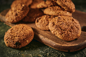 Pile of oat cookies on wooden table, close-up, selective focus
