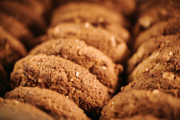 Pile of oat cookies on wooden table, close-up, selective focus