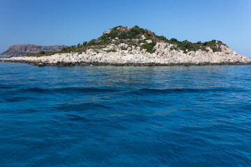 Fototapeta na wymiar Beautiful uninhabited islands surrounded by crisp blue Mediterranean sea near the coast of Kas, Antalya, Turkey.