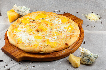 Cheese pizza on a wooden board