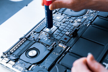 Computer repair man. Pc technician service with laptop on hardware background. Maintenance engineer support. Electronic technology development concept.