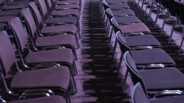 Rows of empty hall chairs. Banning attending events due to quarantine. Lockdown concept. Seats audience organization training business culture event nobody inside