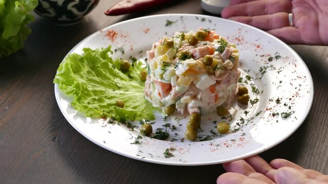 Russian salad olivier on a white plate